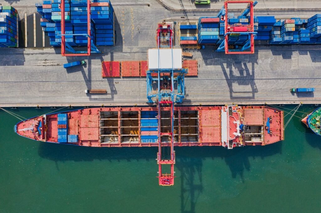 Aerial view of a cargo ship at port near containers