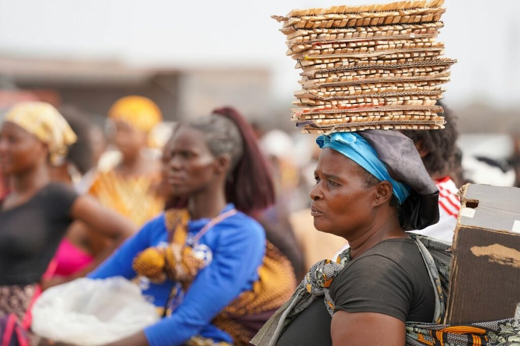 Market trader carrying goods in an African city – fast-growing consumer demand in Africa