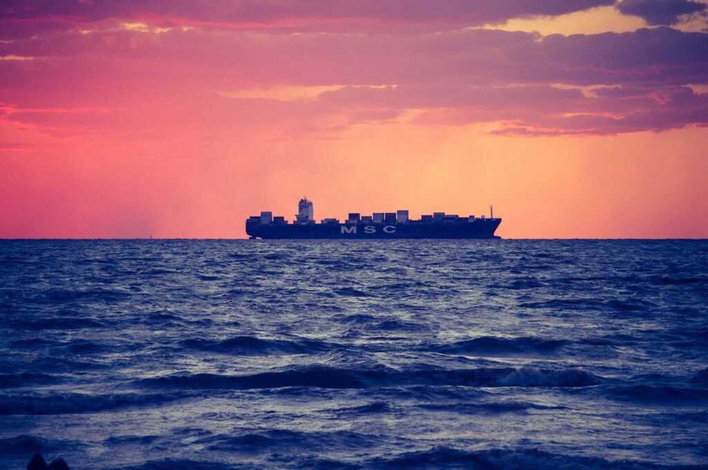 Cargo ship on calm sea at golden hour – shipping Brazilian commodities to world markets