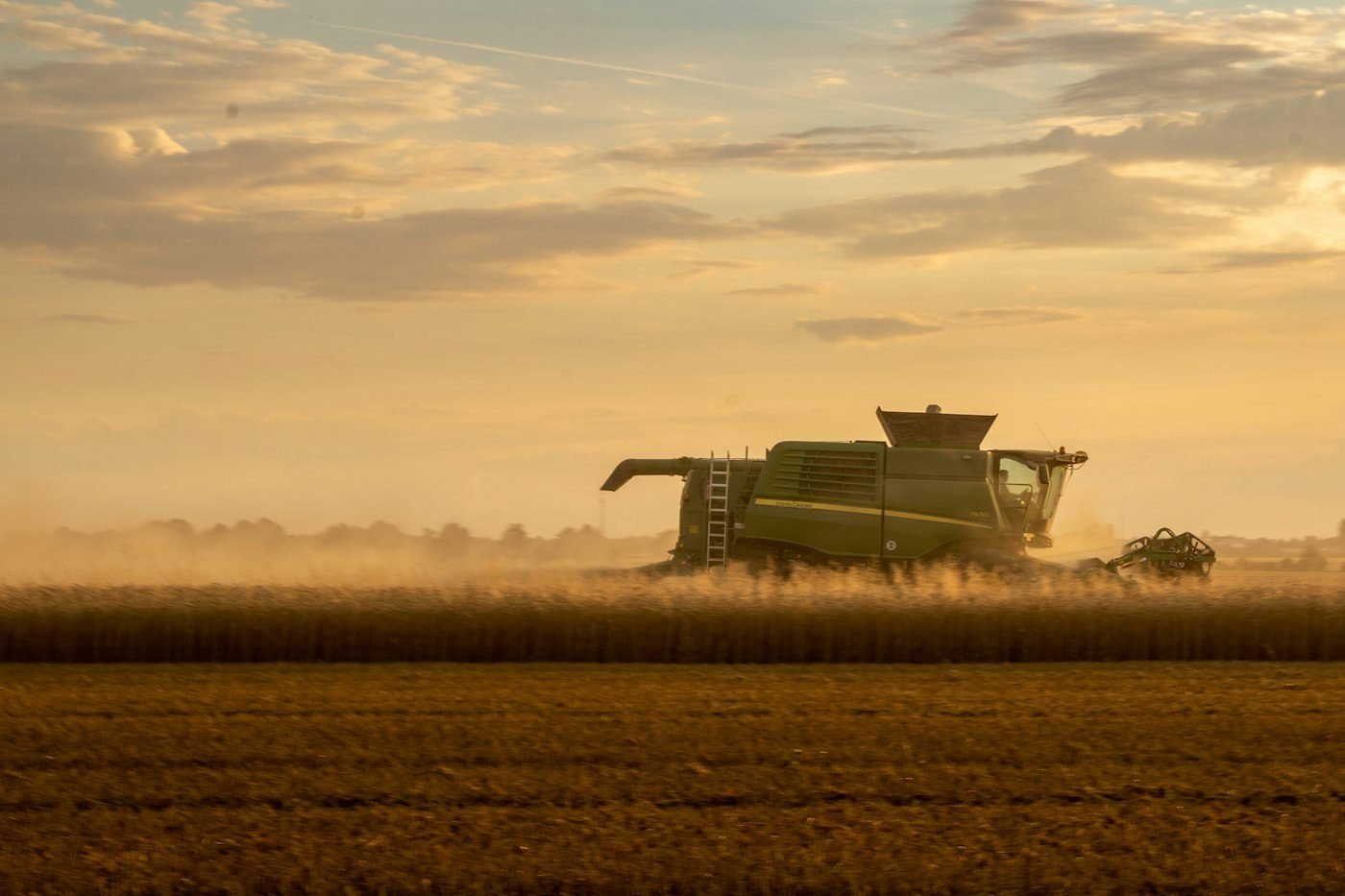 Combine harvester at sunset